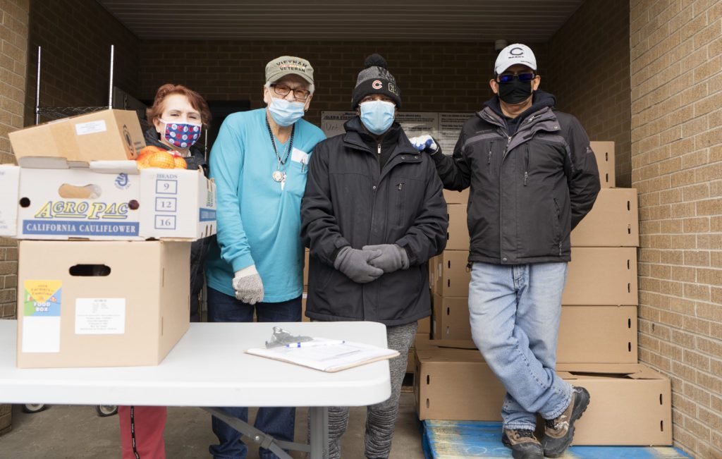 Volunteers pose for a photo at the Iglesia Evangelica Emanuel food pantry in Belmont-Cragin.