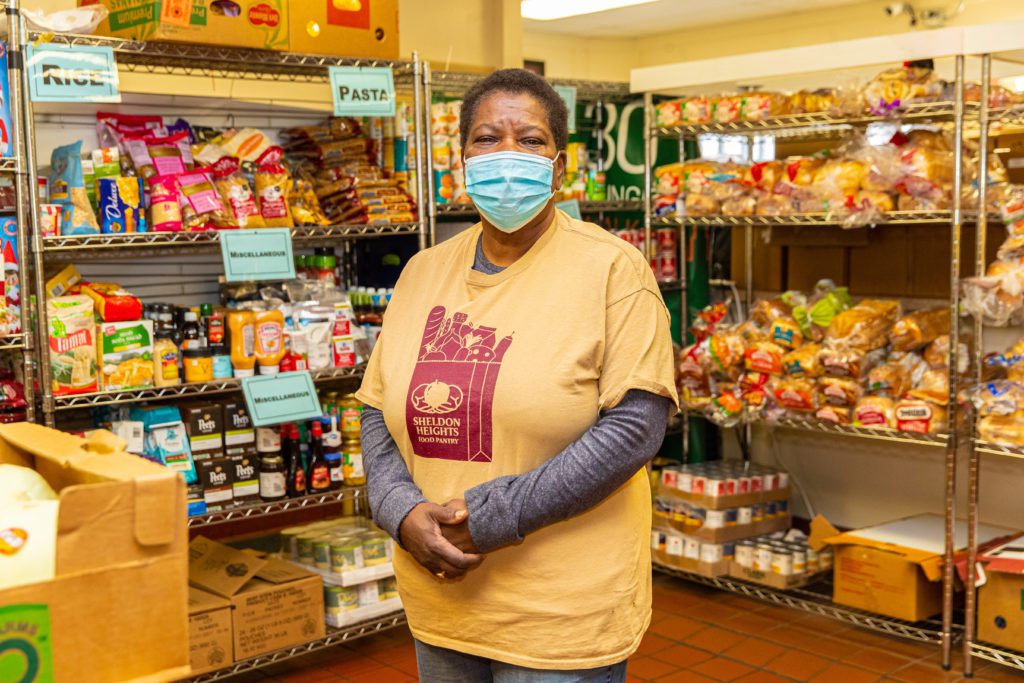 Volunteer leader Wonda Hall stops for a photo inside the Sheldon Heights food pantry