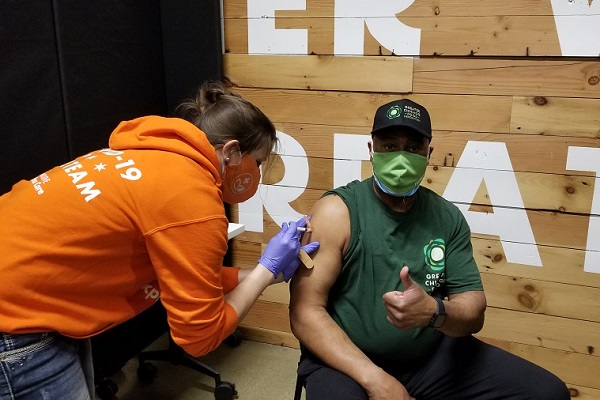 June Williams receives the first dose of the COVID-19 vaccine.