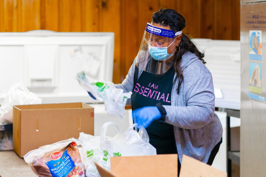 Outreach coordinator Darriel Anderson prepares bags of food for her food pantry visitors.