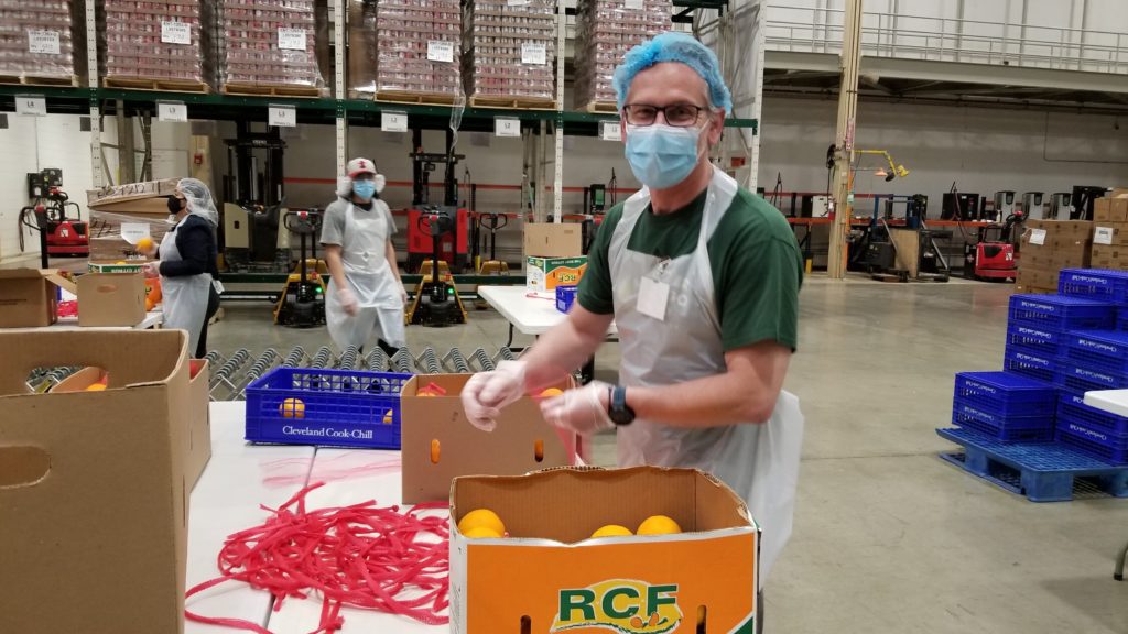Victor Lew repacking oranges during a recent volunteer session.