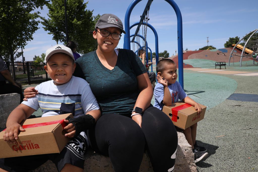 Aida Salazar and her sons, Cresencio and Conrado, at the La Villita Park Lunch Bus stop