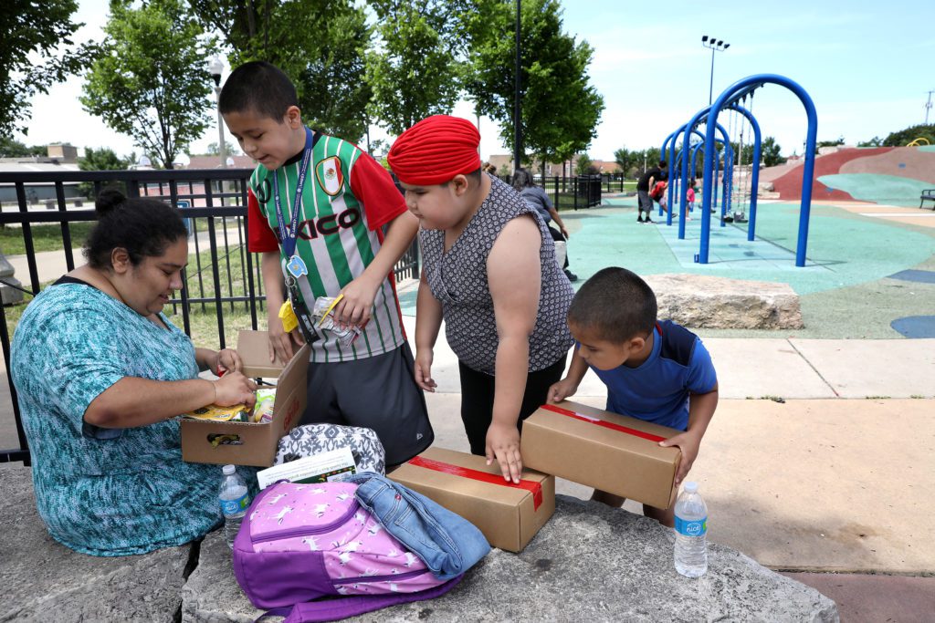 Elva Guerrero and her three kids – 13-year-old Martin, 8-year-old Ana, and 6-year-old James – stopped by Lunch Bus stop at La Villita Park.