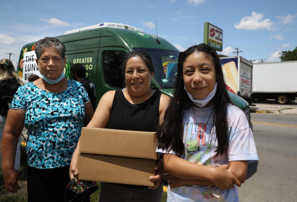 (From left) Maria de La Luz Sanchez, Aoa Castillo, and Musa Sanchez pick up Lunch Bus meals in Berwyn