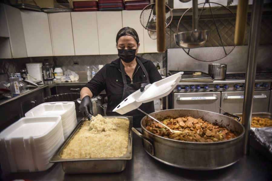 Socorro Zapata serving food for St. Pius Soup Kitchen guests. (Photos by Carolina Sanchez for the Food Depository)