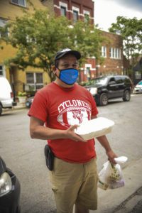 Roberto Sandoval with food from the St. Pius community soup kitchen