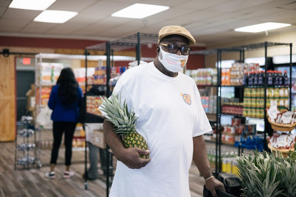 Volunteer Emmett Cobb poses for a photo in the Free-N-Deed food pantry