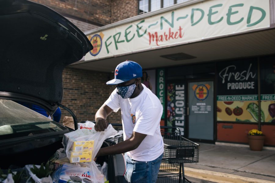 Volunteer Anthony Pinckney fills a guest's car with groceries at the Free-N-Deed Market food pantry in Dolton