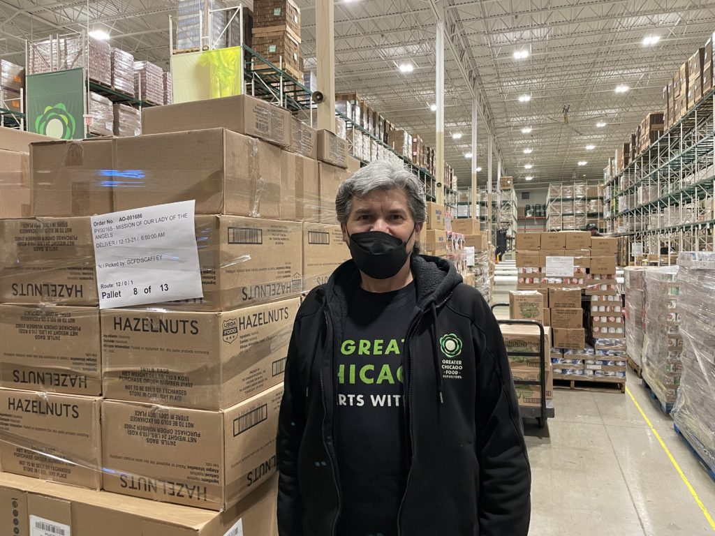 Efrain Reyes, a driver for the Food Depository, poses for a photo in the warehouse