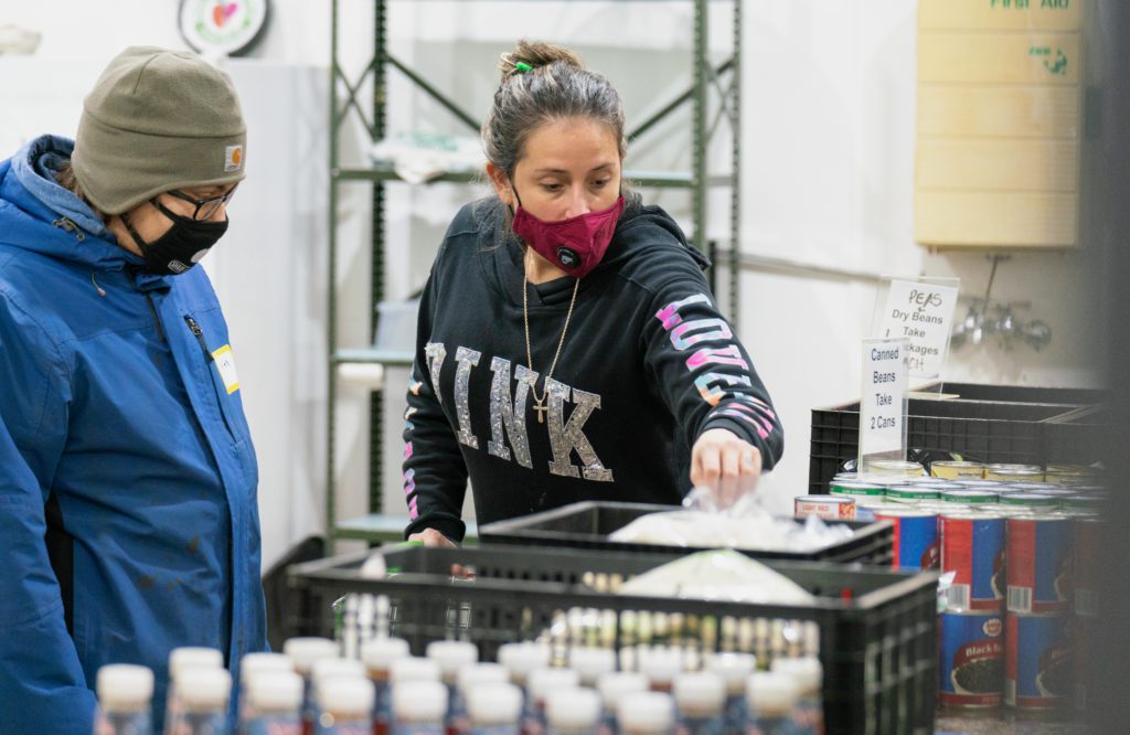 Amber Lofton picks out food at the Share Food Share Love food pantry in Brookfield.