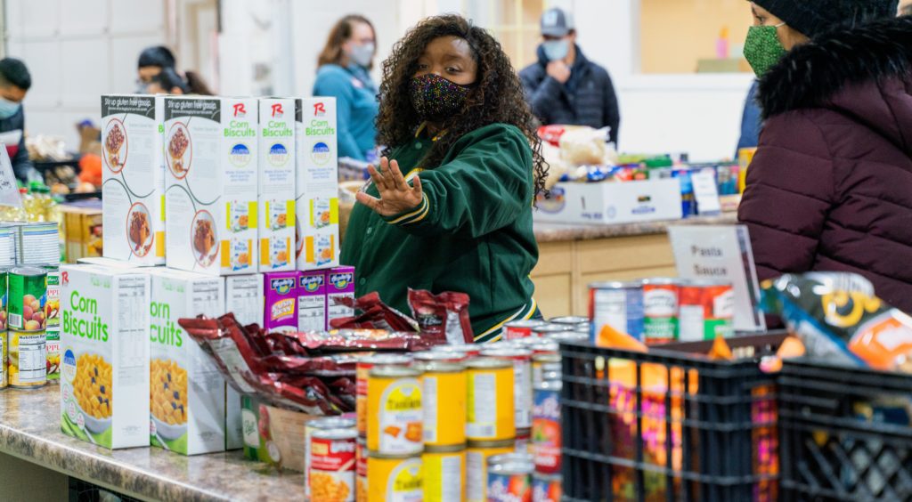 Volunteer Maya Brooks helps visitors during a recent distribution.