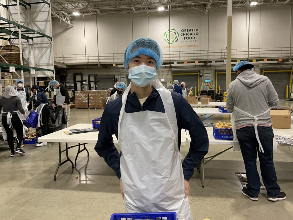 Edmund Leong packs food in the Food Depository warehouse