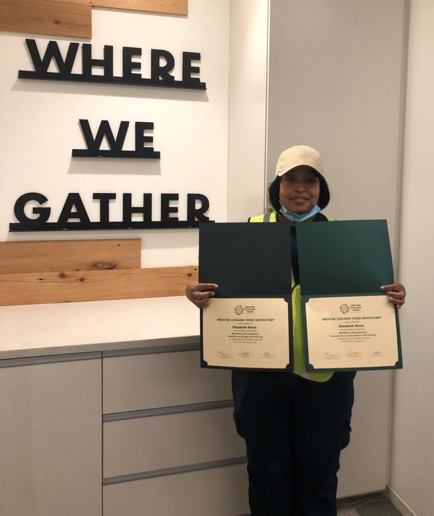 Elizabeth Davis poses with her completion certification for the Food Depository's Certified Logistics Associate program.