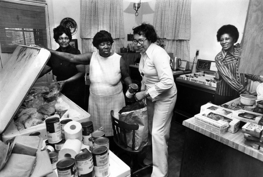Gertrude Snodgrass, second from left, and other volunteers pack food to be given away on Chicago's West Side on Aug. 17, 1979.