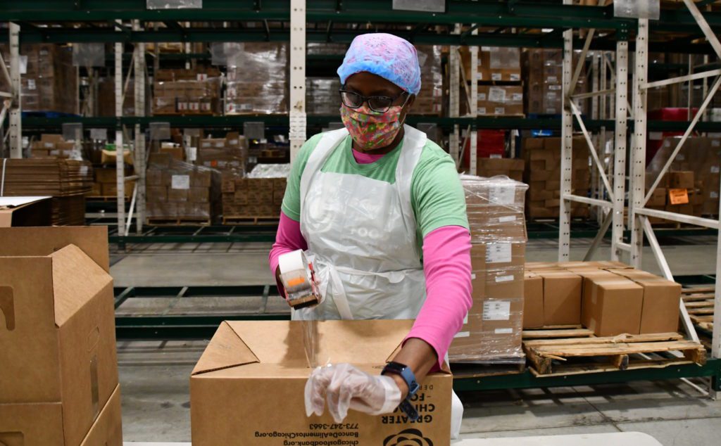 Sherrie Dentley assembles boxes in the Food Depository warehouse during a volunteer session.