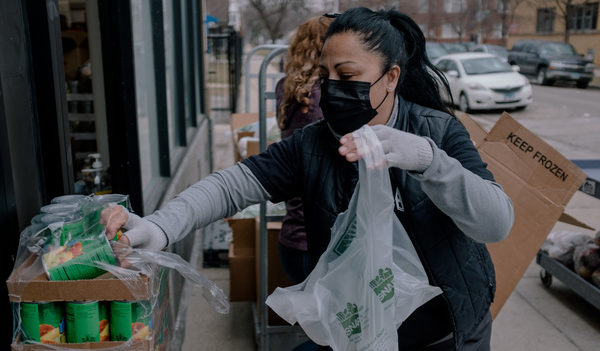 SANAD Food Pantry Volunteer bagging food