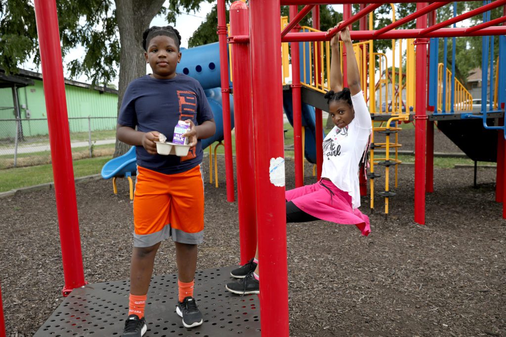 Aaron and Anna Peters play and eat at Smith Park