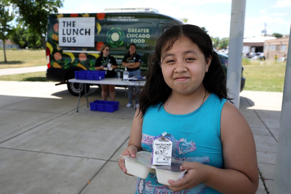 A girl poses in front of the La Villita Lunch Bus stop