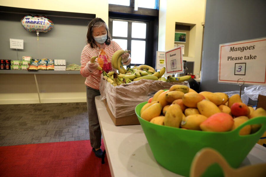 Helen Han puts out fresh food for a older adult community market at LaSalle Street Church (photos by Nancy Stone for the Food Depository)