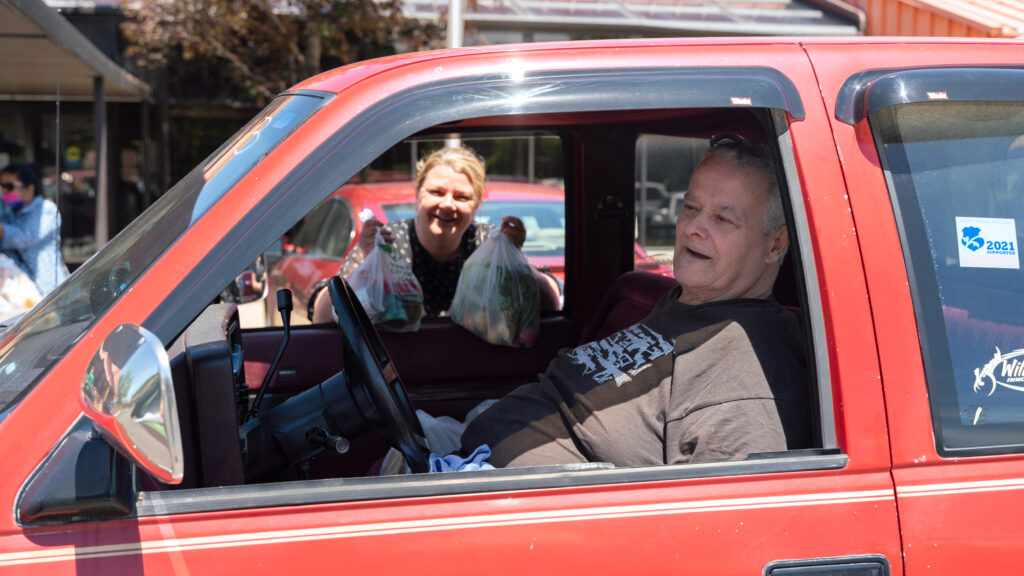 Robert Costner picks up groceries for himself and her neighbors at Pav YMCA