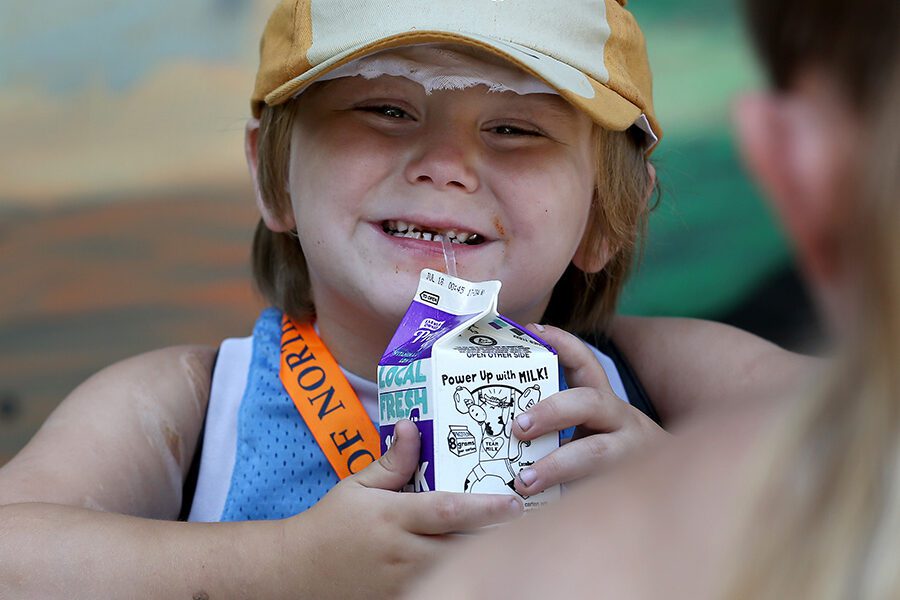 A child with a carton of milk