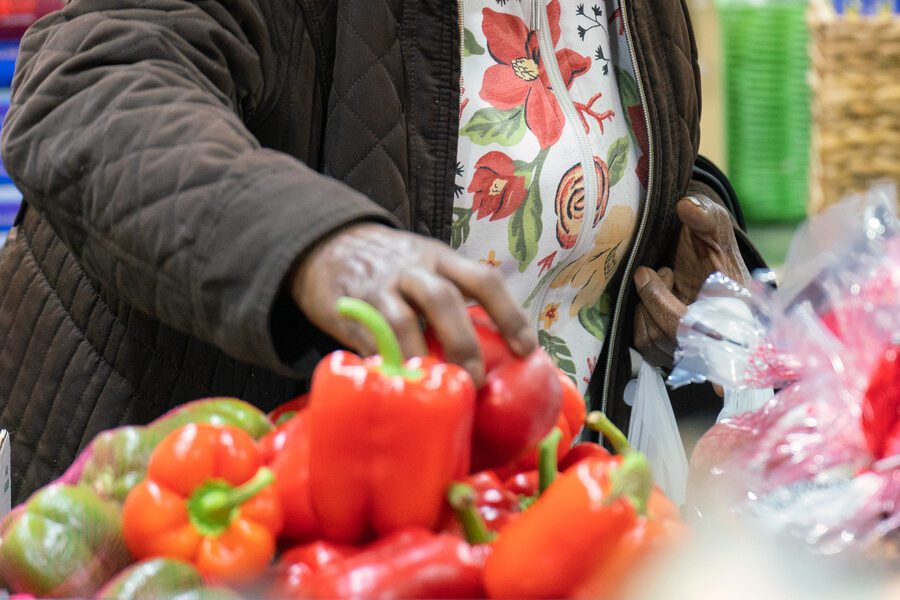 Person reaching for fresh vegetables