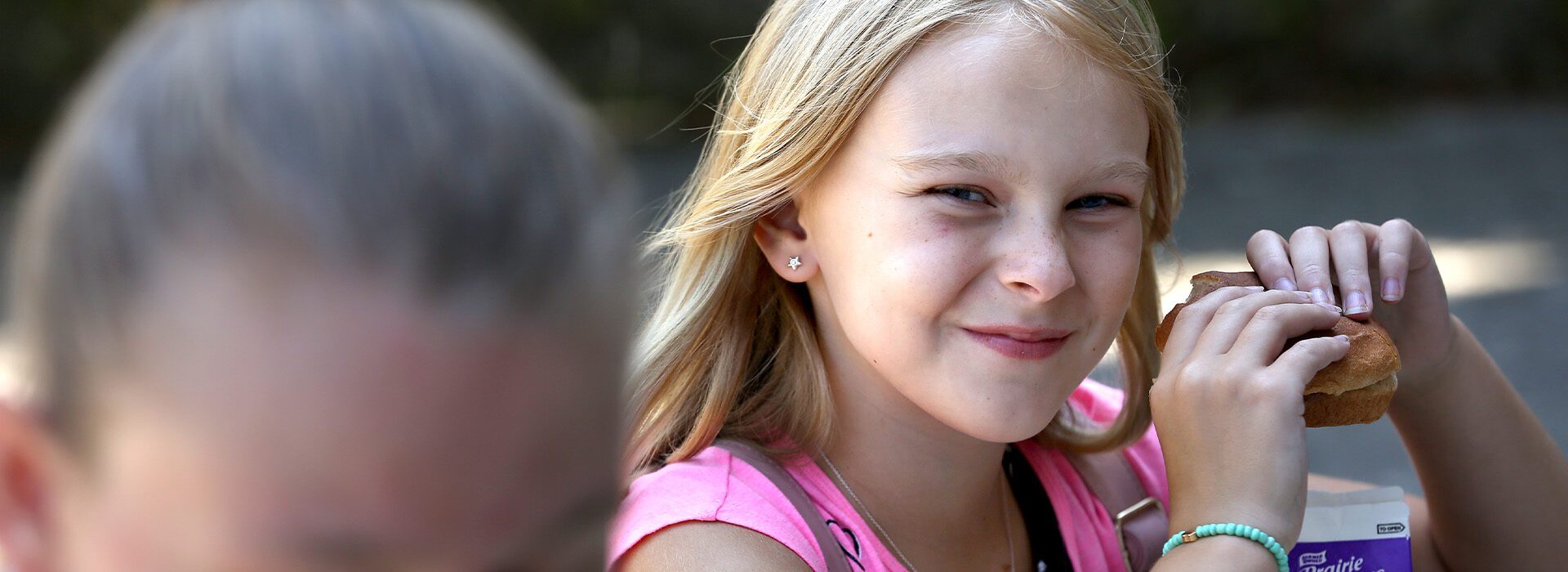 Young girl eating a sandwich