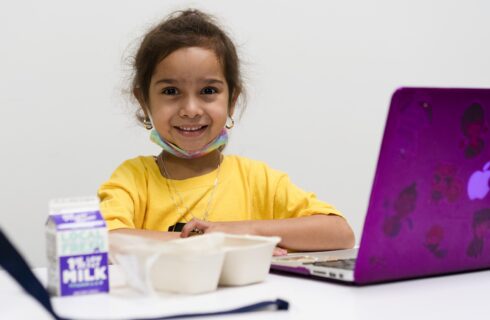 Child with laptop and meal