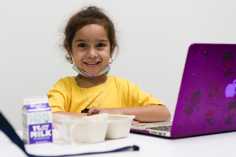 Child with laptop and meal