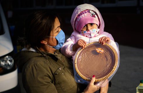 Child and woman holding a pie