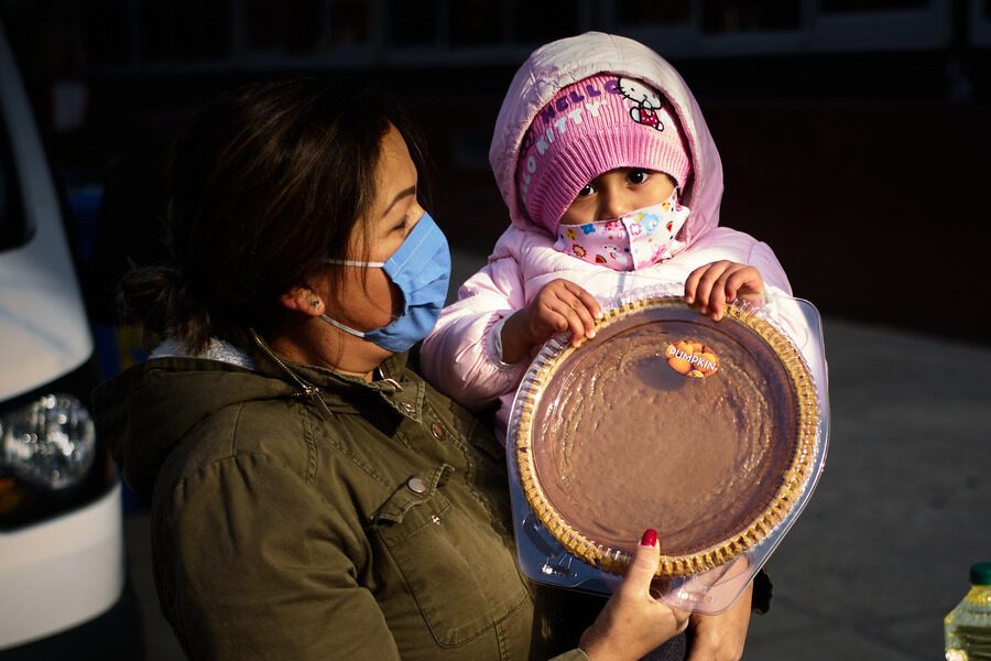 Child and woman holding a pie