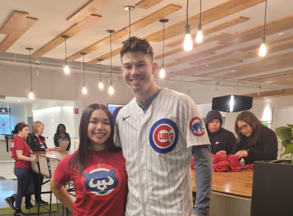 a young athlete with a Cubs player