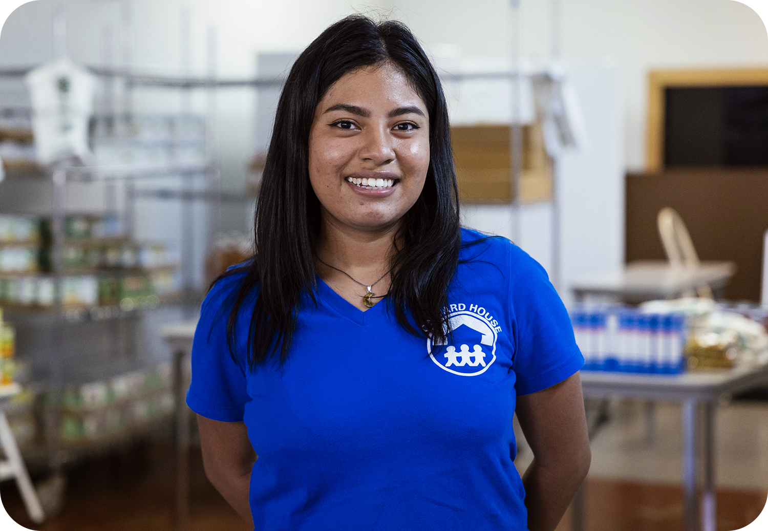 Lupe kindness shows through as she greets other at the pantry.