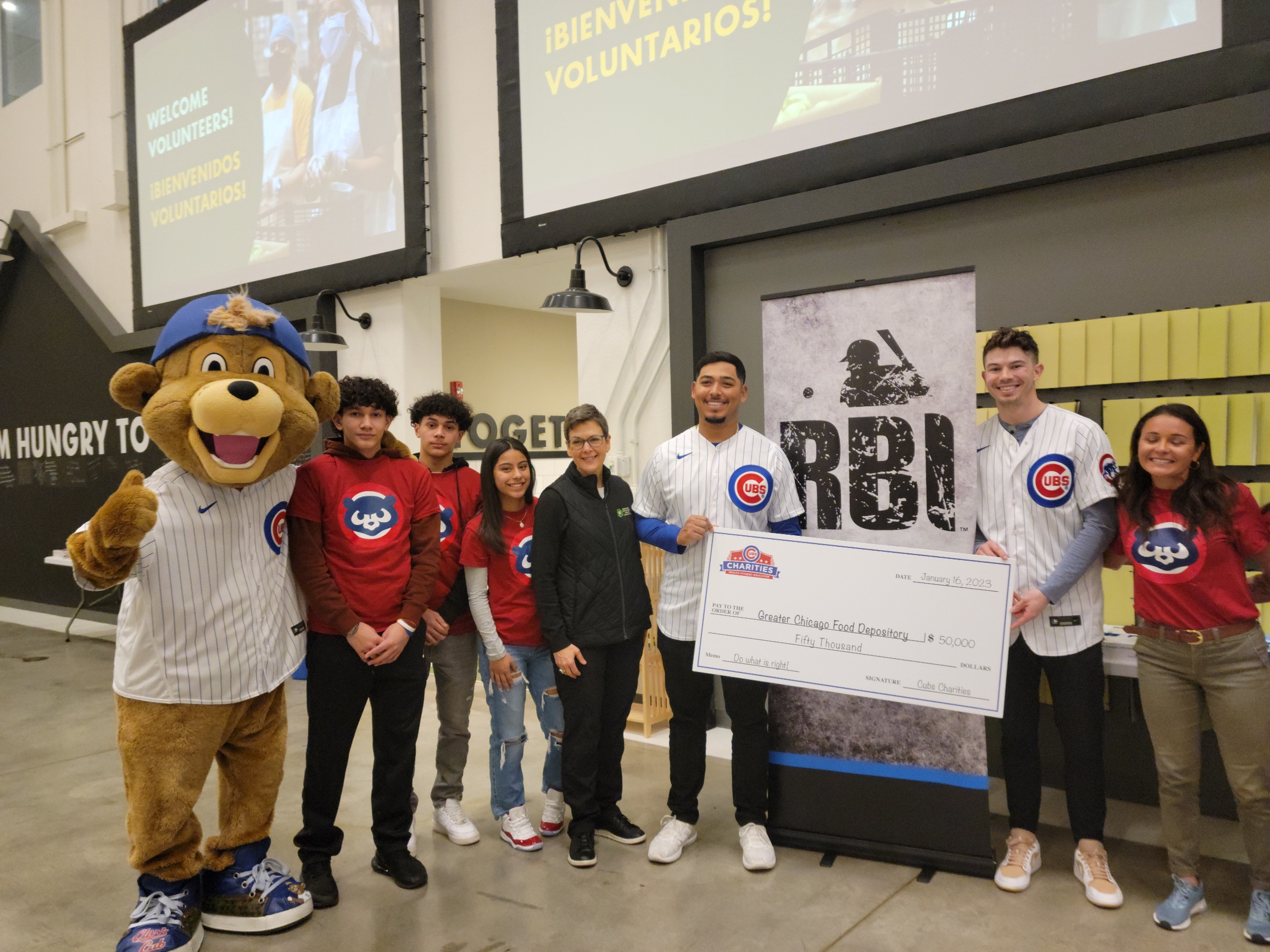 young athletes and Cubs players donate to the Food Depository