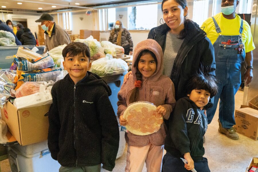 a mother and her three children at a food pantry