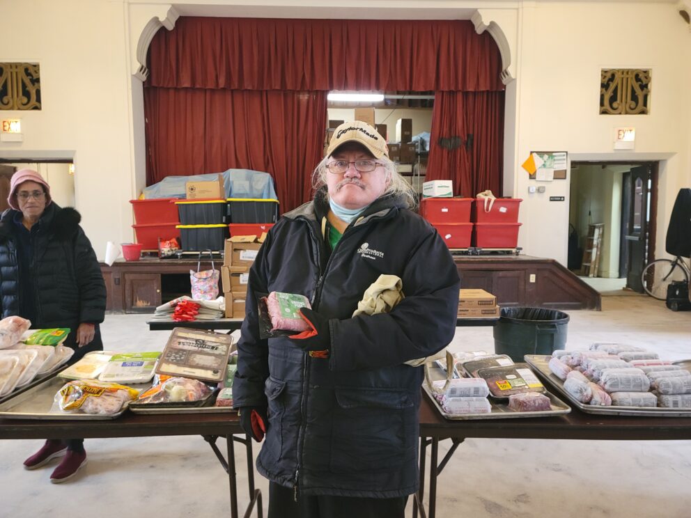 a man stands in a food pantry