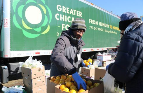 a man distributes produce at a food pantry