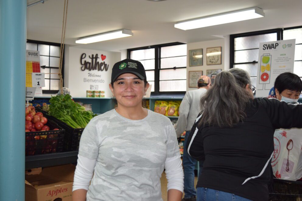 a woman in a ball cap smiles at the camera