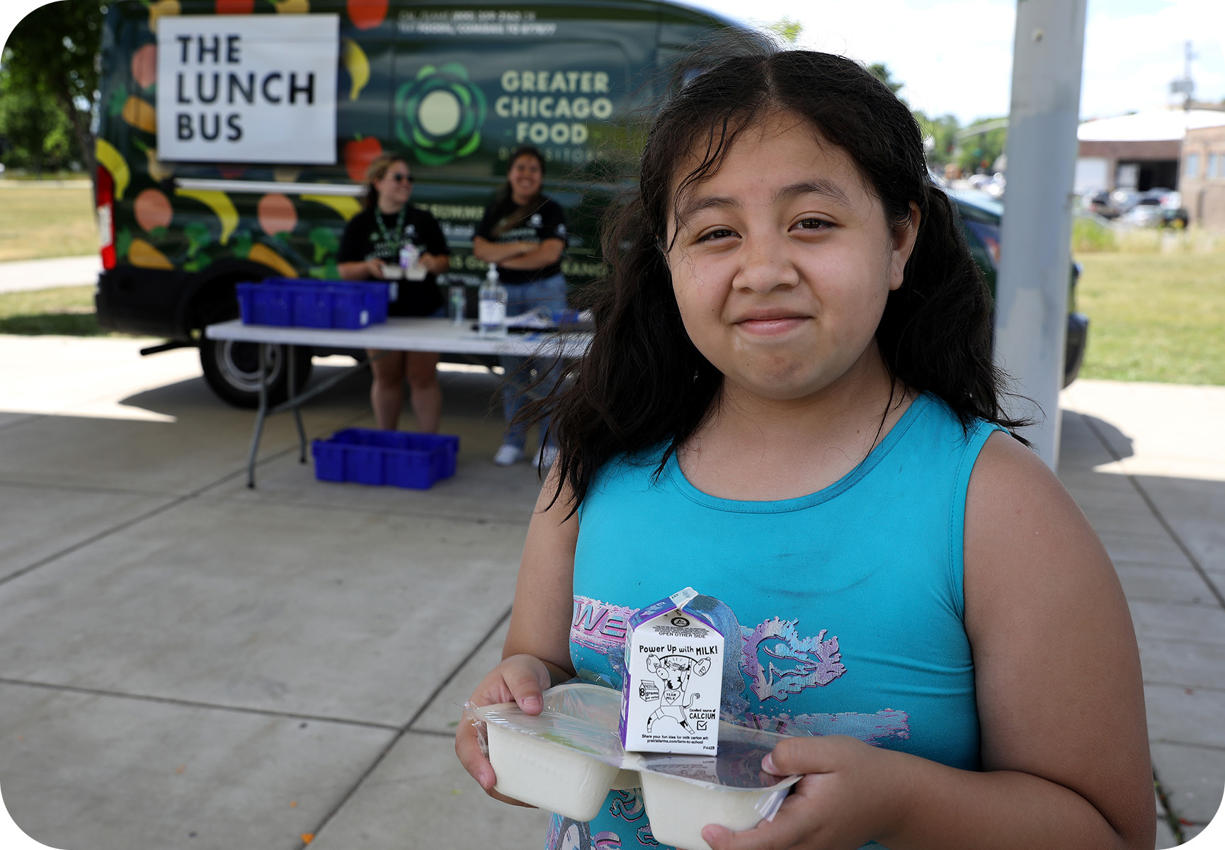 A child received her nutritious lunch provided by the Greater Chicago Food Depository Lunch Bus.