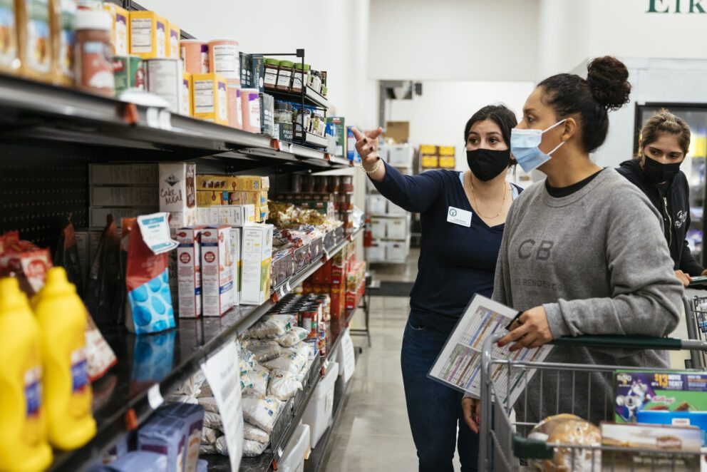 two women shop at a food pantry