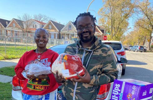 A couple holds up food they've received