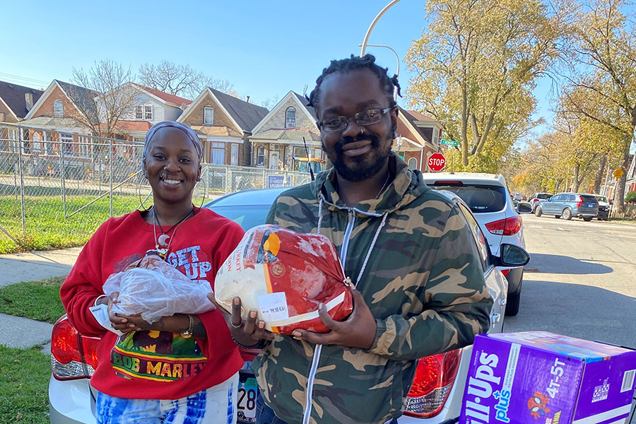 A couple holds up food they've received