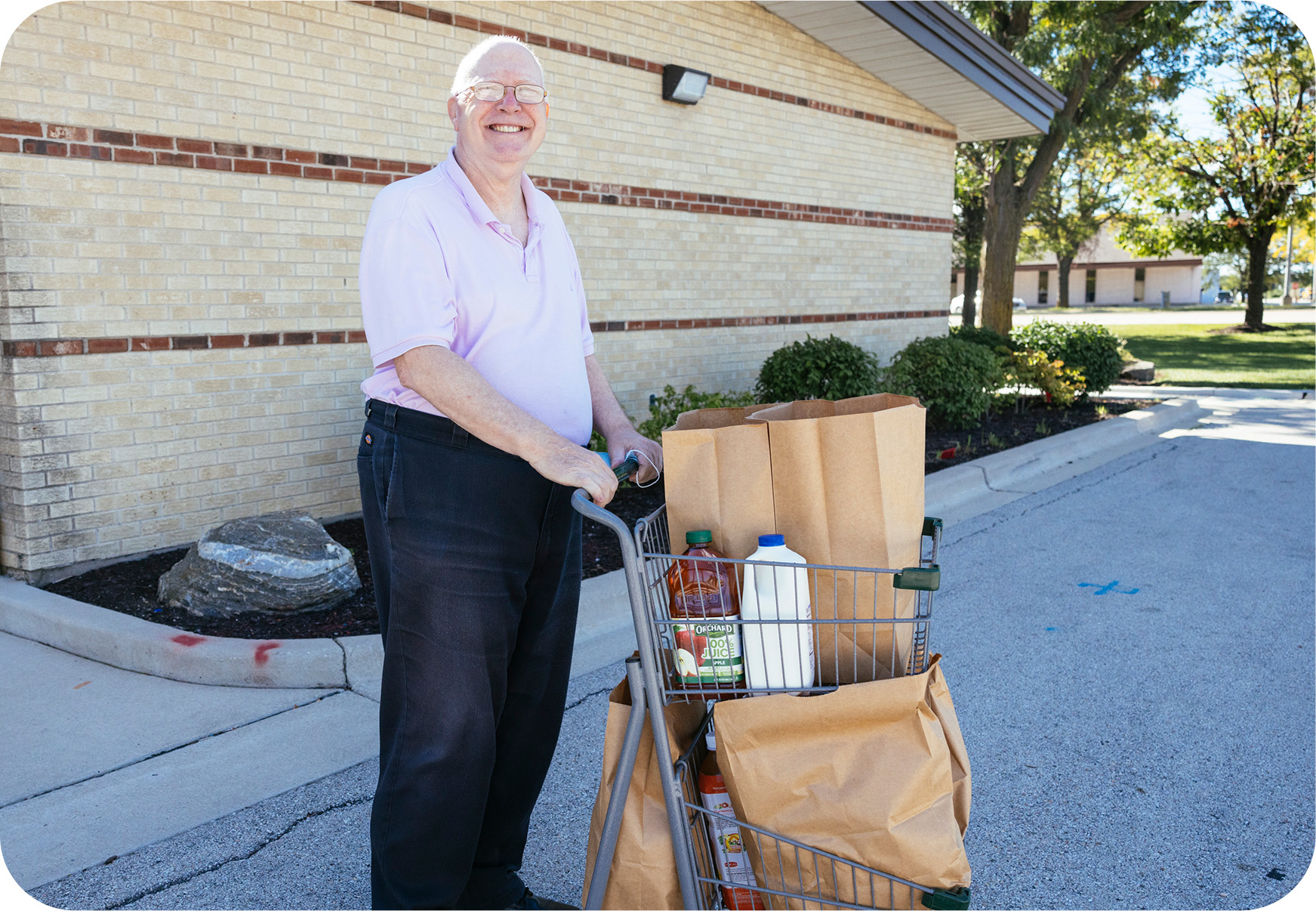 An older adult who just received groceries from a local food pantry.