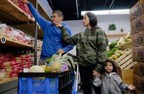 A family shops for produce.