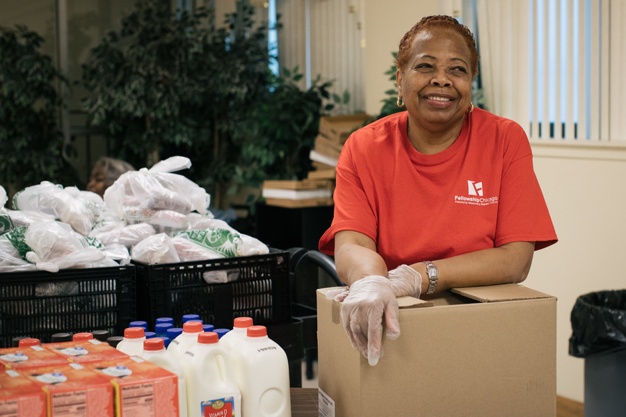 Pantry volunteer with box and food