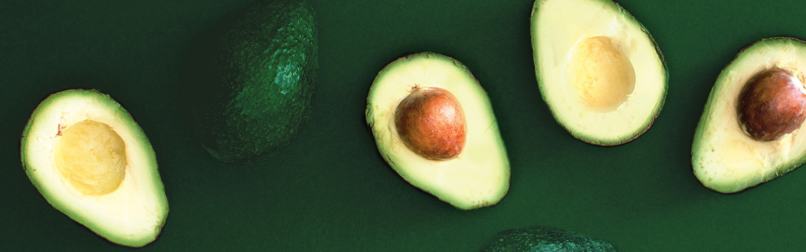 Several fresh, halved avocados.