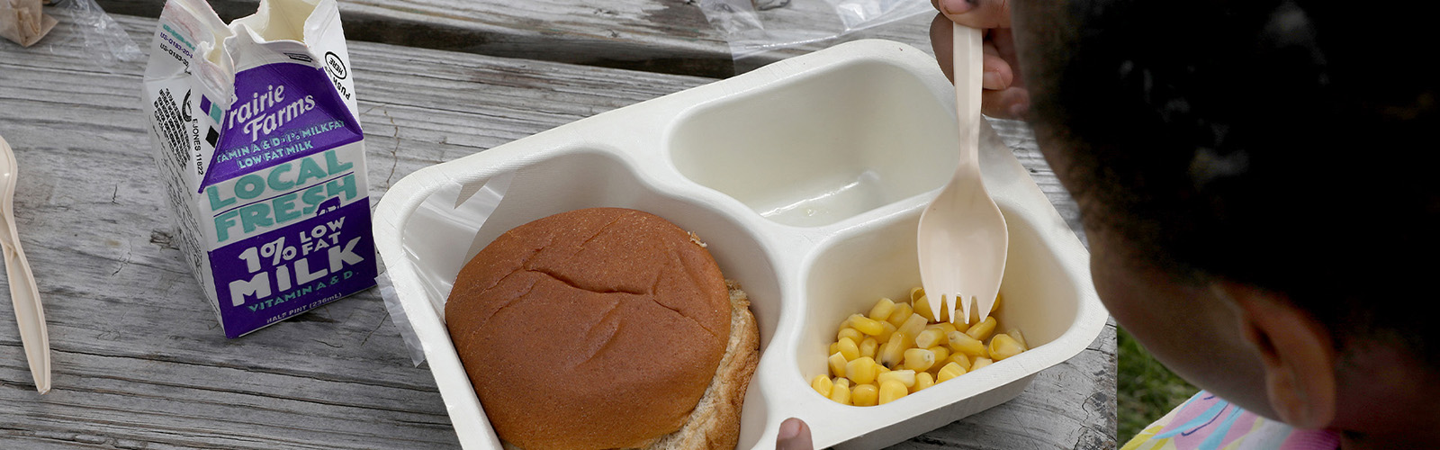 Lunch tray with food and a carton of milk.