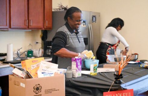 Marvin Ware helping to make a hamburger mac and cheese at Hope Manor II's cooking class