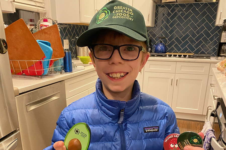 a boy in a ballcap smiles at the camera