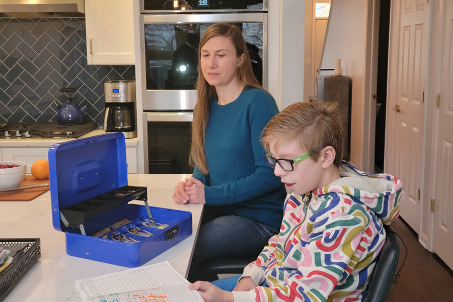 a boy and his mother sit at their kitchen island